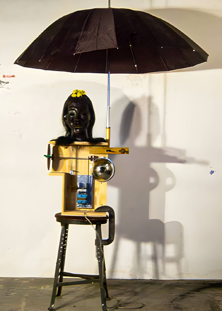 Lady in blue 605. 200x120 cm. wax, wood, electric motor, umbrella, and found objects. 2005